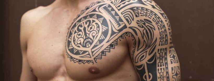 superb polynesian tribal tattoo on left chest and shoulder for men